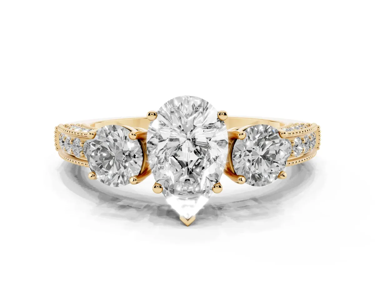 Pear Cut Three-Stone Diamond Ring with Pavé Band and Four-Prong Setting Yellow gold