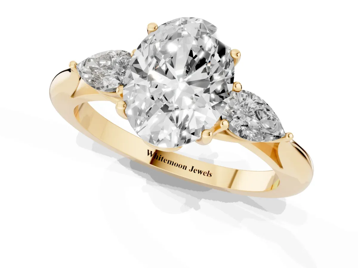 Three-Stone Oval Cut Brilliant Diamond Solitaire Ring with Tapered Band and Four-Prong Setting Yellow gold