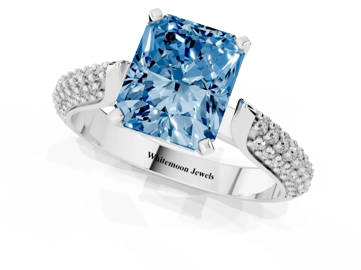 Fancy Blue Radiant Cut Diamond Solitaire Engagement Ring with Multi-Row Round Pavé Band and Prong Setting White gold