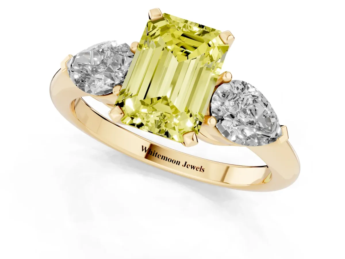 Fancy Yellow Three-Stone Emerald Cut Diamond Ring with Pear Side Stones and Four-Prong Setting Yellow gold