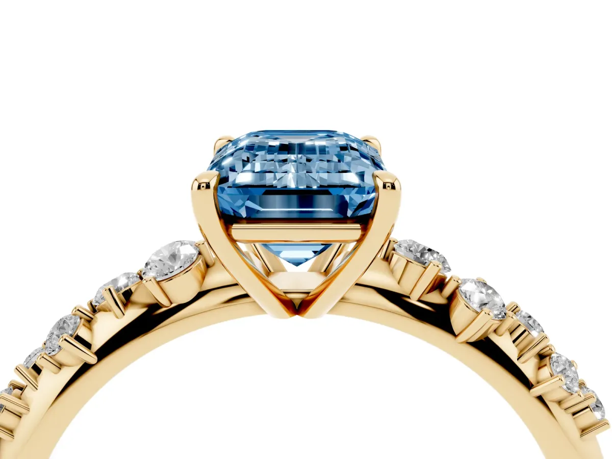 Fancy Blue Emerald Cut Diamond Cluster Side Stone Solitaire Ring with Prong Setting Yellow gold