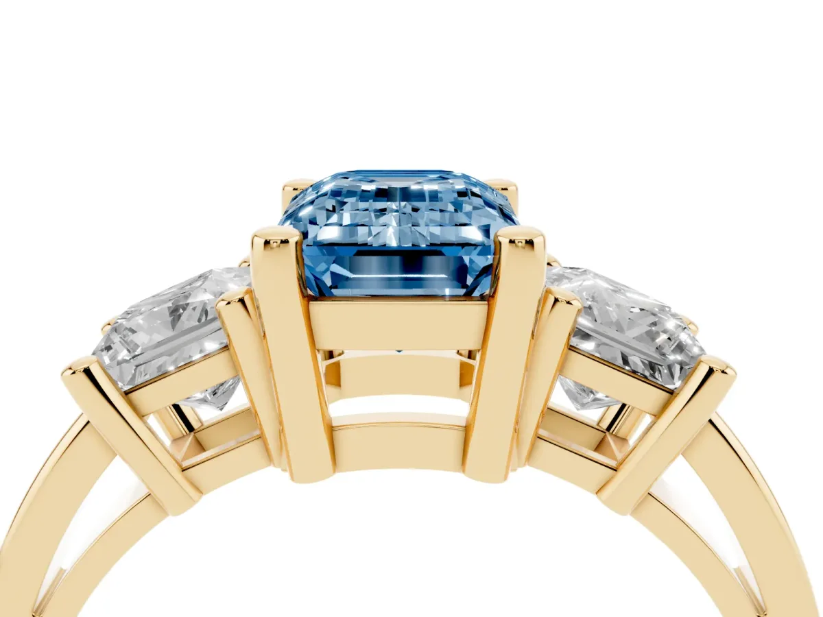 Fancy Blue Three-Stone Emerald Cut Cut Solitaire Ring with Prong Setting Yellow gold