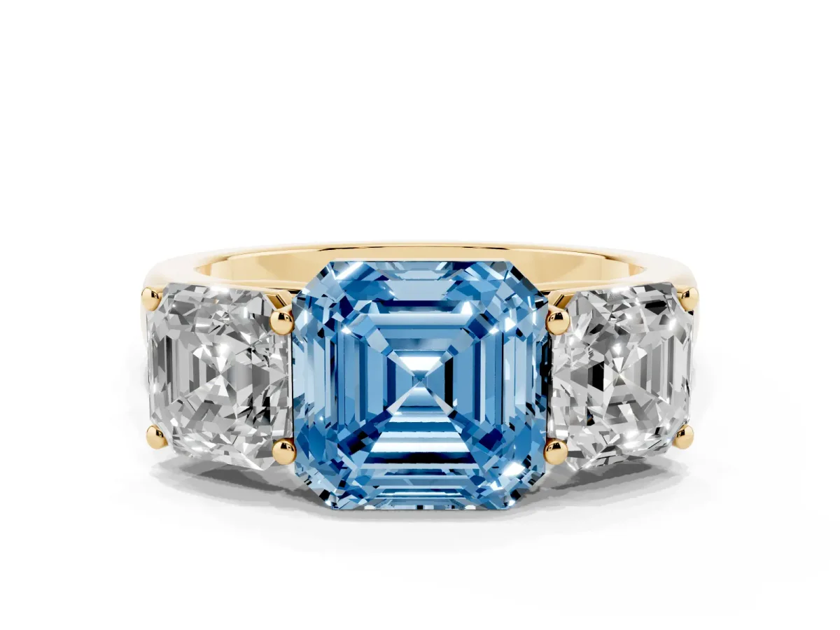 Fancy Blue Asscher Cut Three-Stone Diamond Ring with Prong Setting on a Classic Band Yellow gold