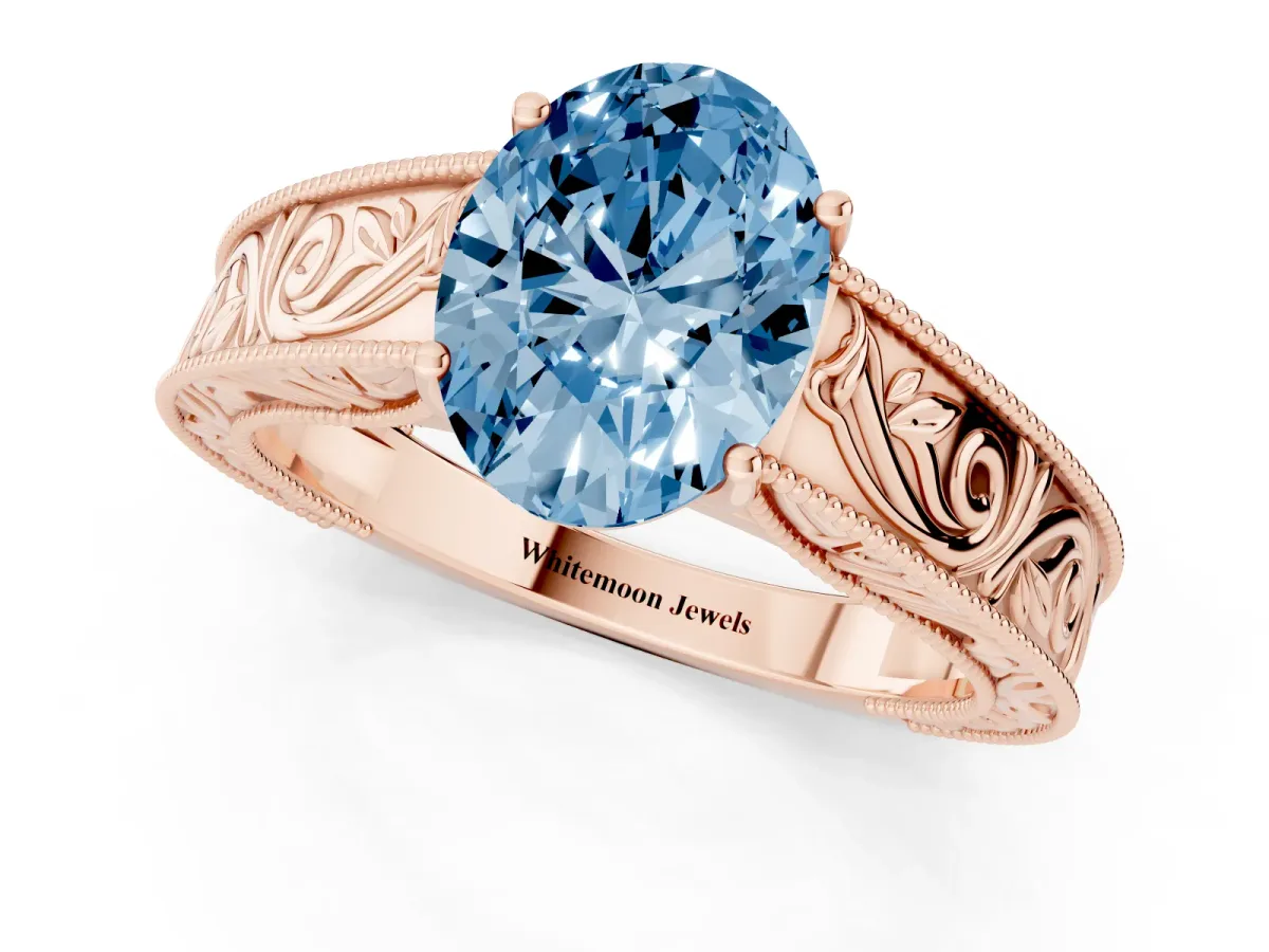 Fancy Blue Oval Cut Diamond Solitaire Ring with Engraved Band and Four-Prong Setting Rose gold