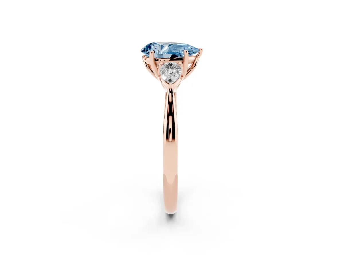Fancy Blue Three-Stone Pear Cut Diamond Ring with Pear Side Stones in Four-Prong Setting Rose gold