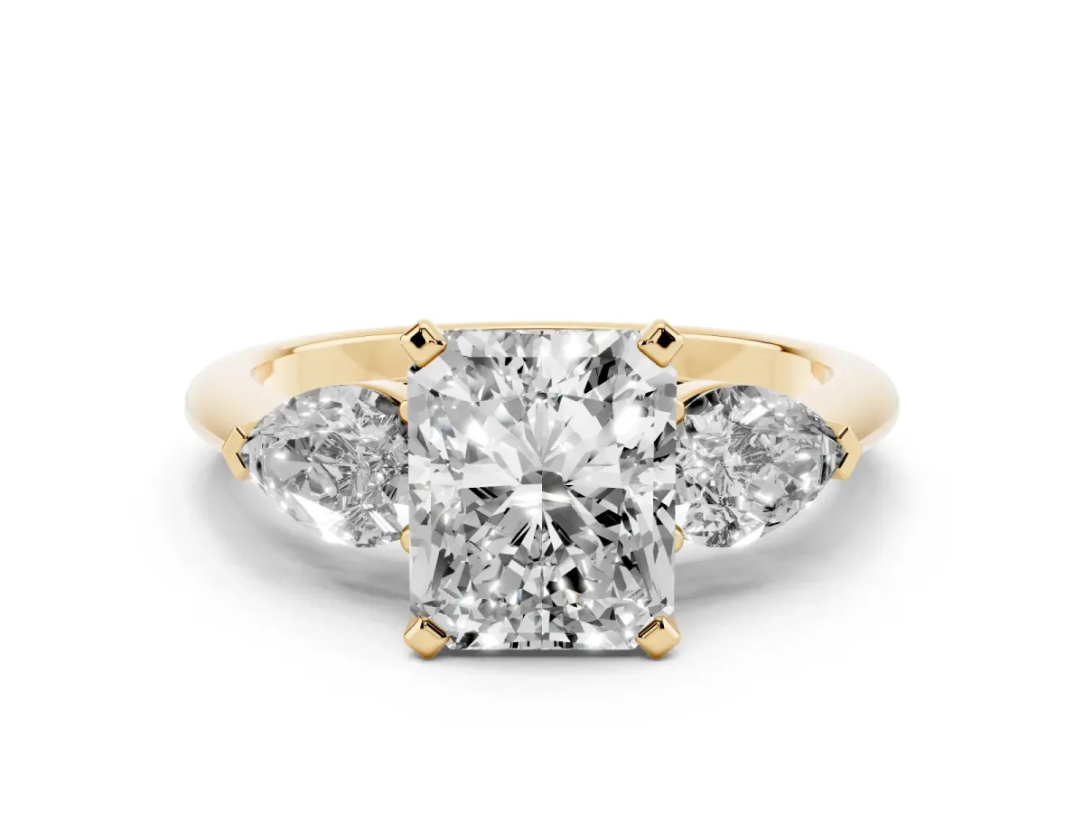 Three-Stone Radiant Cut Diamond Ring with Pear Side Stones and Four-Prong Setting Yellow gold