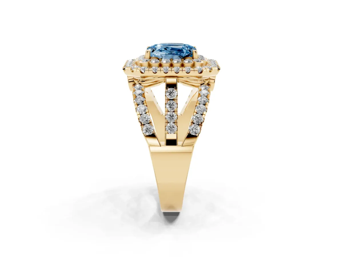 Fancy Blue Emerald Cut Diamond Double Halo Ring with Round Pavé Split Shank and Prong Setting Yellow gold