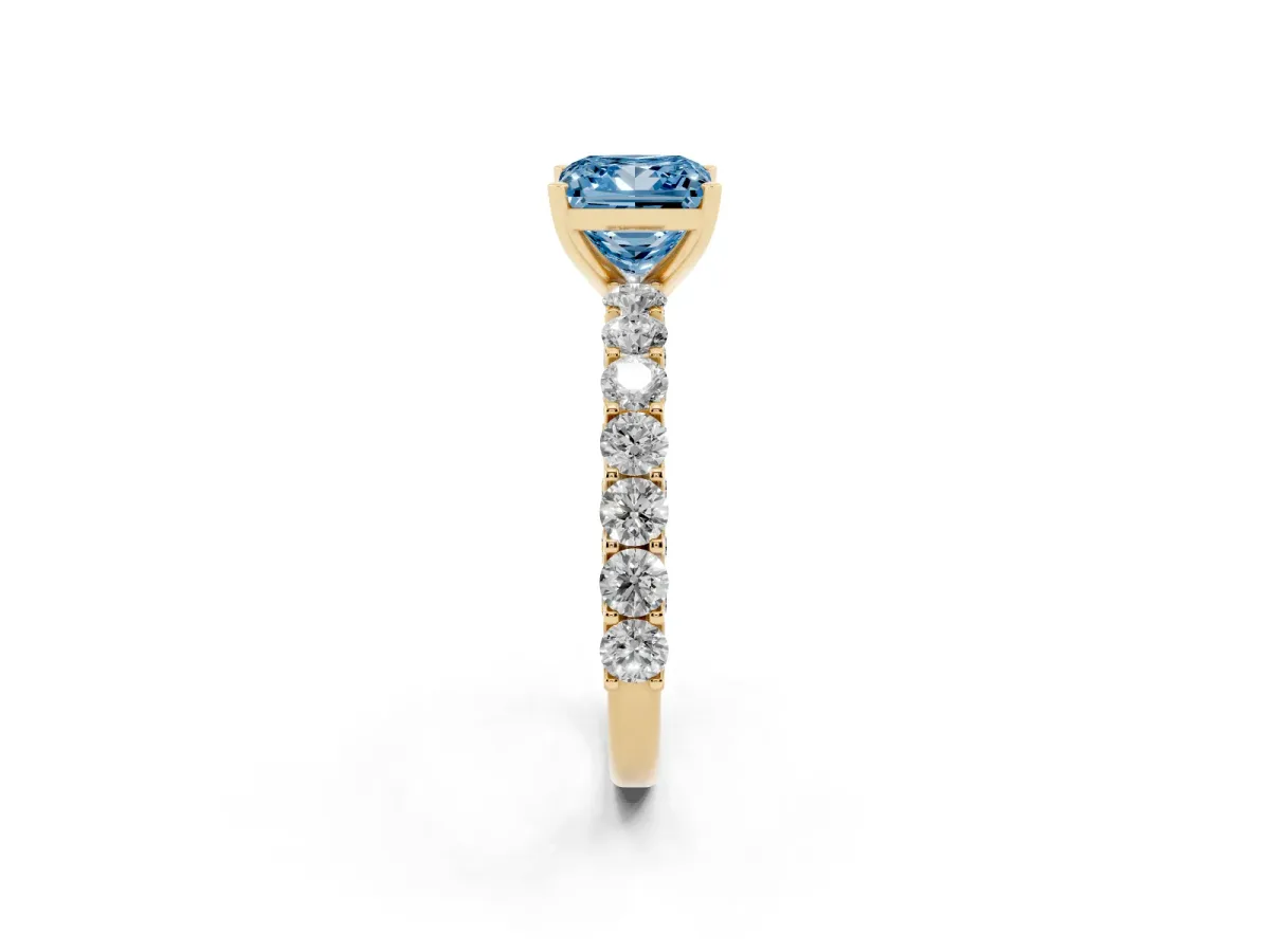Fancy Blue Princess Cut Diamond Solitaire Ring with Shared Prong Pavé Band and Four-Prong Setting Yellow gold