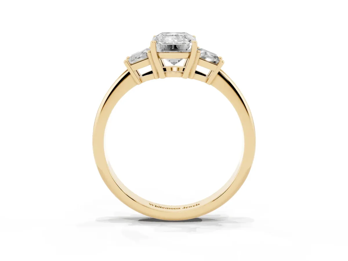 Emerald Cut Diamond Three-Stone Ring with Trapezoid Side Stones and Prong Setting Yellow gold