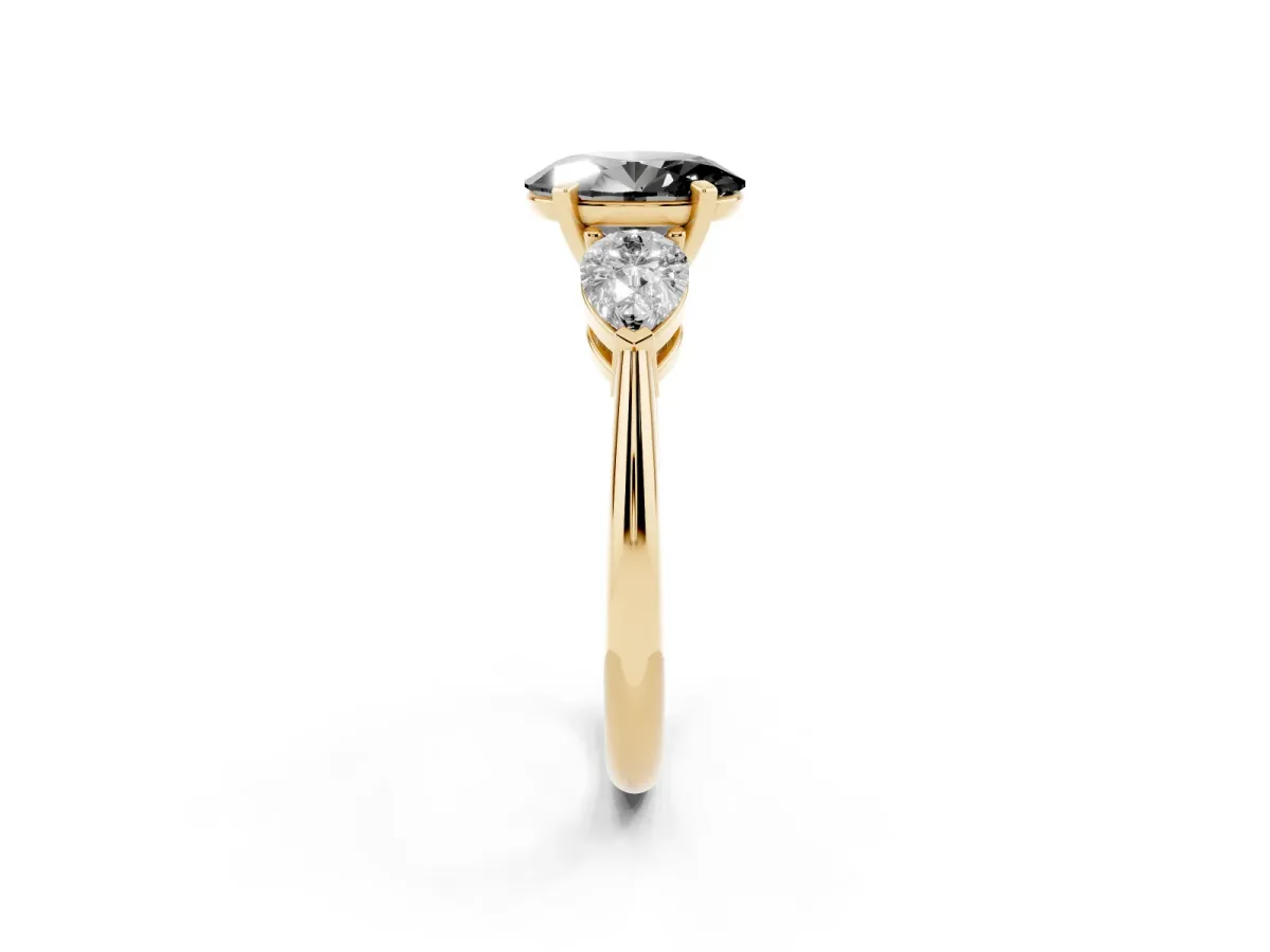 Fancy Black Three-Stone Oval Cut Diamond Ring with Pear Side Stones and Four-Prong Setting Yellow gold