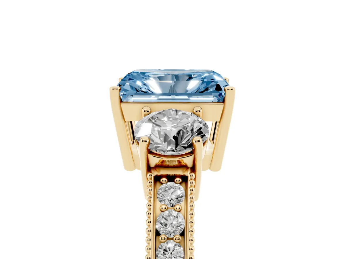 Fancy Blue Radiant Cut Three-Stone Diamond Ring with Pavé Band and Four-Prong Setting Yellow gold