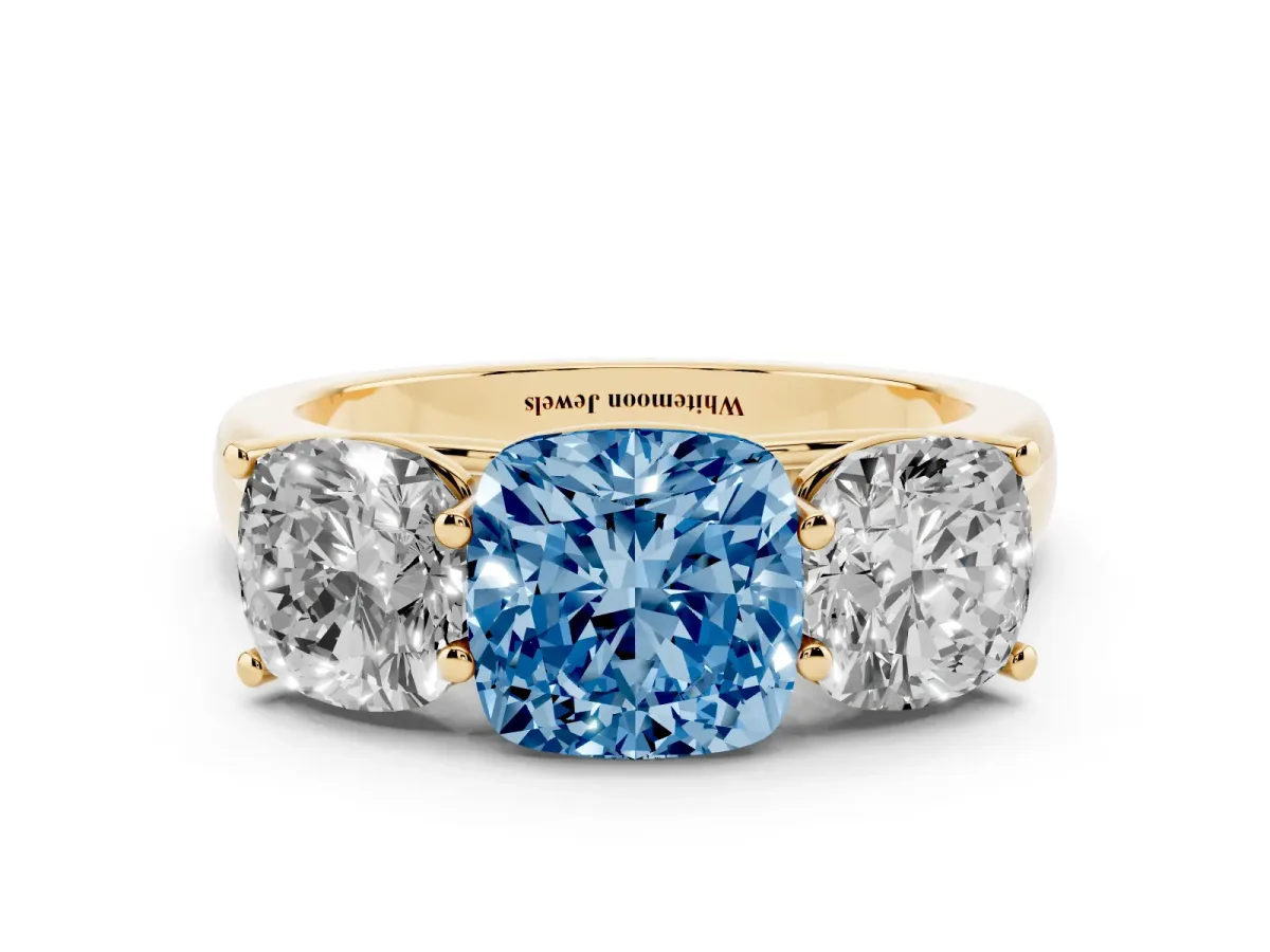 Fancy Blue Cushion Cut Three-Stone Diamond Ring with Prong Setting on a Classic Band Yellow gold