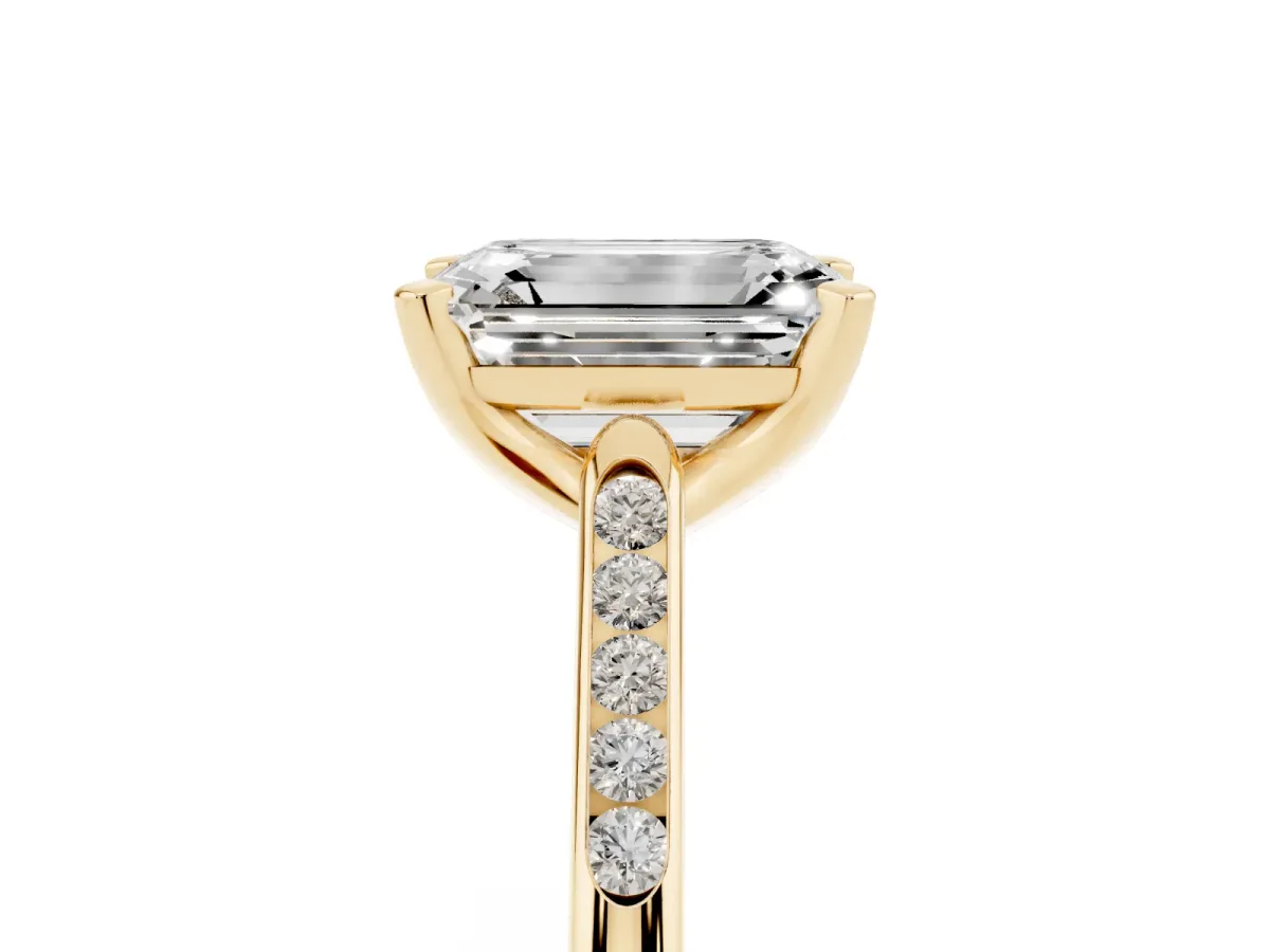 Emerald Cut Diamond Solitaire Ring with Channel Set Round Band and Prong Setting Yellow gold