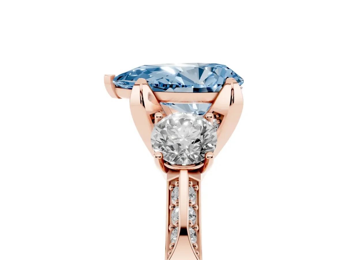 Fancy Blue Pear Cut Brilliant Three-Stone Diamond Ring with Pavé Band and Four-Prong Setting Rose gold