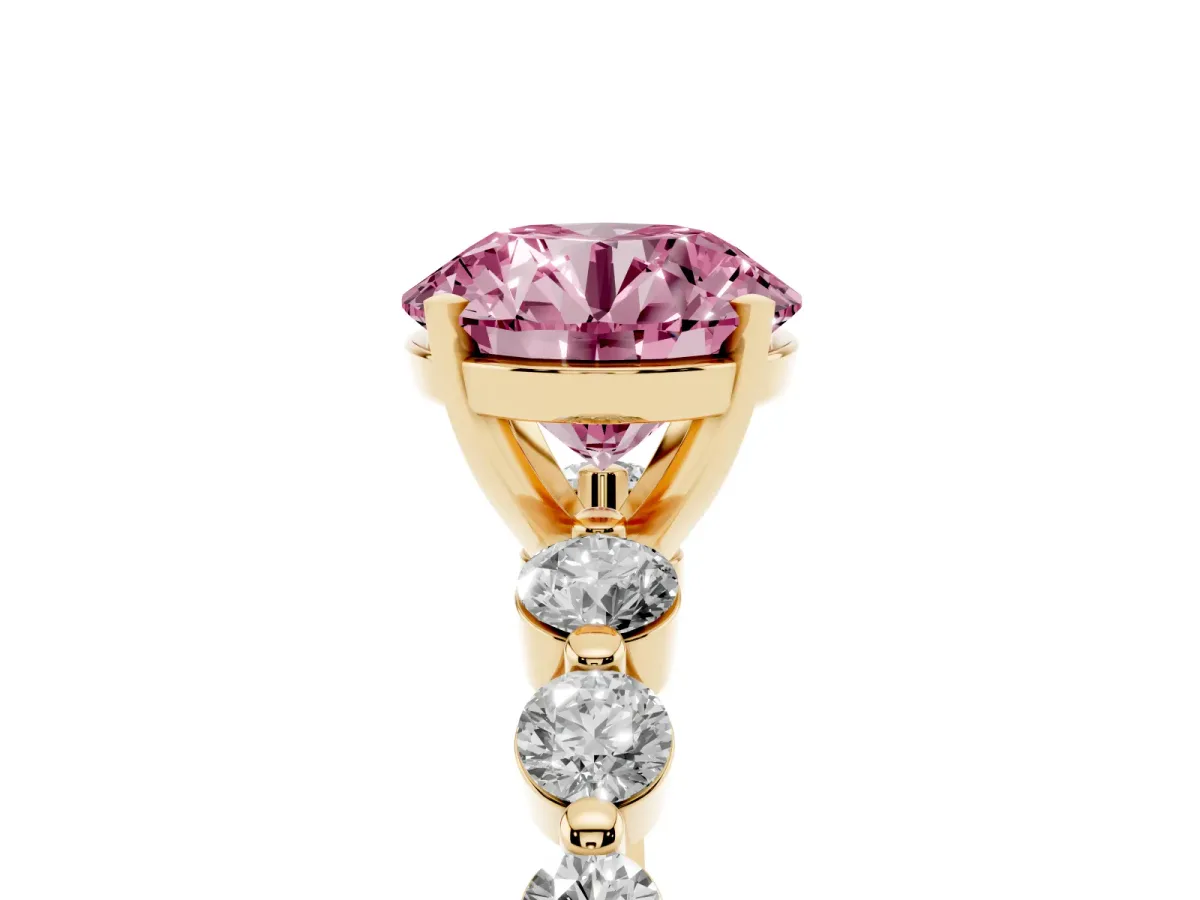 Fancy Pink Round Cut Solitaire Diamond Ring with Pave Band and Four-Prong Setting Yellow gold