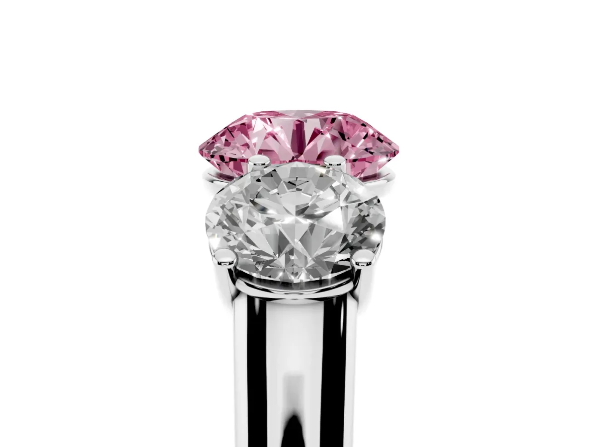 Fancy Pink Round Cut Three-Stone Diamond Ring with Prong Setting on a Classic Band Platinum