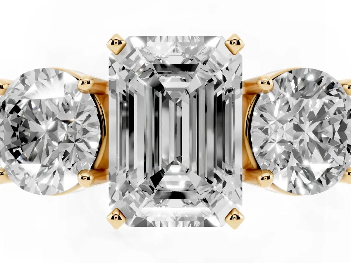 Three-Stone Emerald Cut Diamond Ring with Round Side Stones, Classic Band, and Four-Prong Setting Yellow gold
