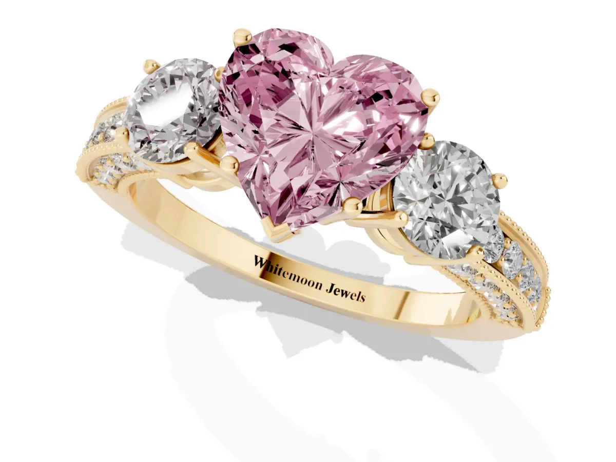 Fancy Pink Heart Cut Three-Stone Diamond Ring with Pavé Band and Four-Prong Setting Yellow gold