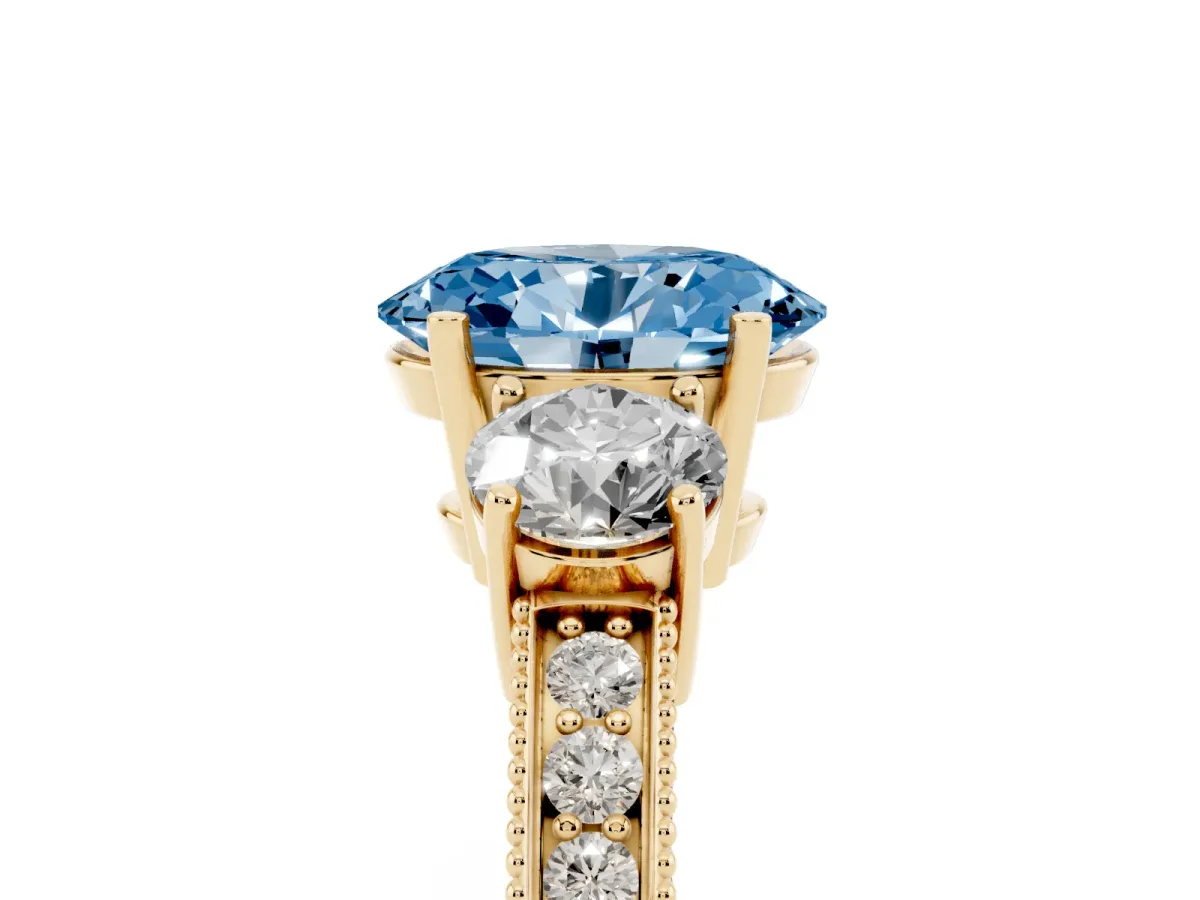 Fancy Blue Oval Cut Three-Stone Diamond Ring with Pavé Band and Four-Prong Setting Yellow gold