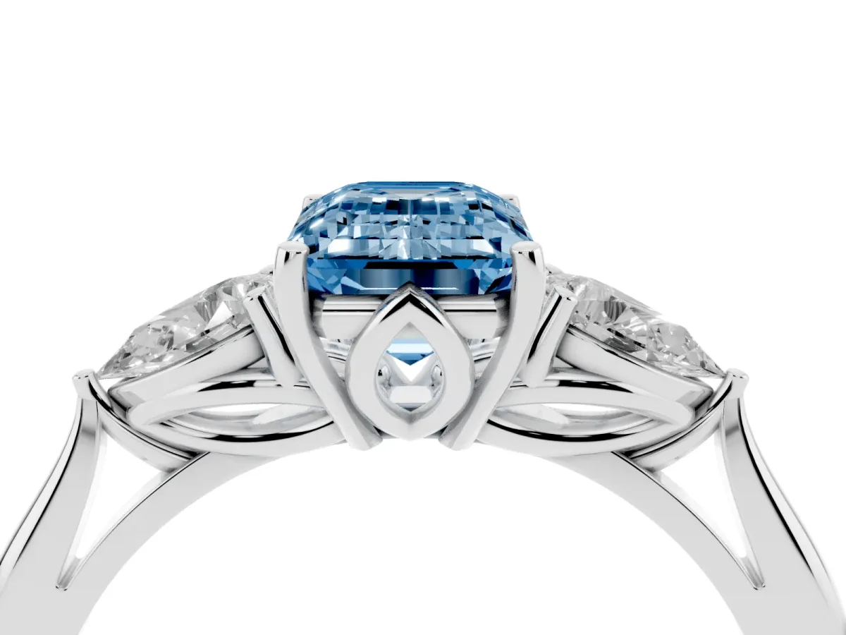 Fancy Blue Three-Stone Emerald Cut Brilliant Diamond Solitaire Ring with Tapered Band and Four-Prong Setting White gold