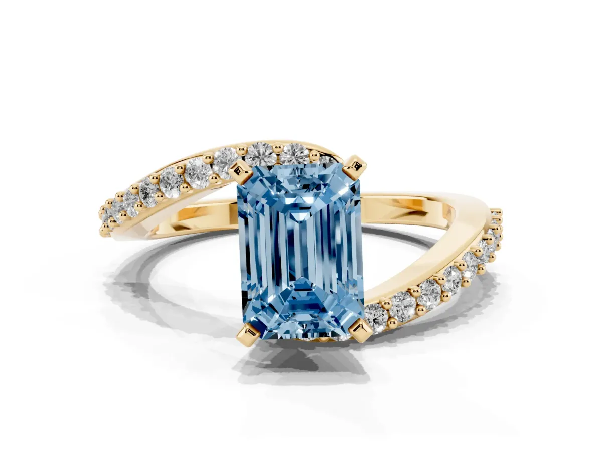 Fancy Blue Emerald Cut Solitaire Twist Band with Pave Set Diamonds and Four-Prong Setting Yellow gold