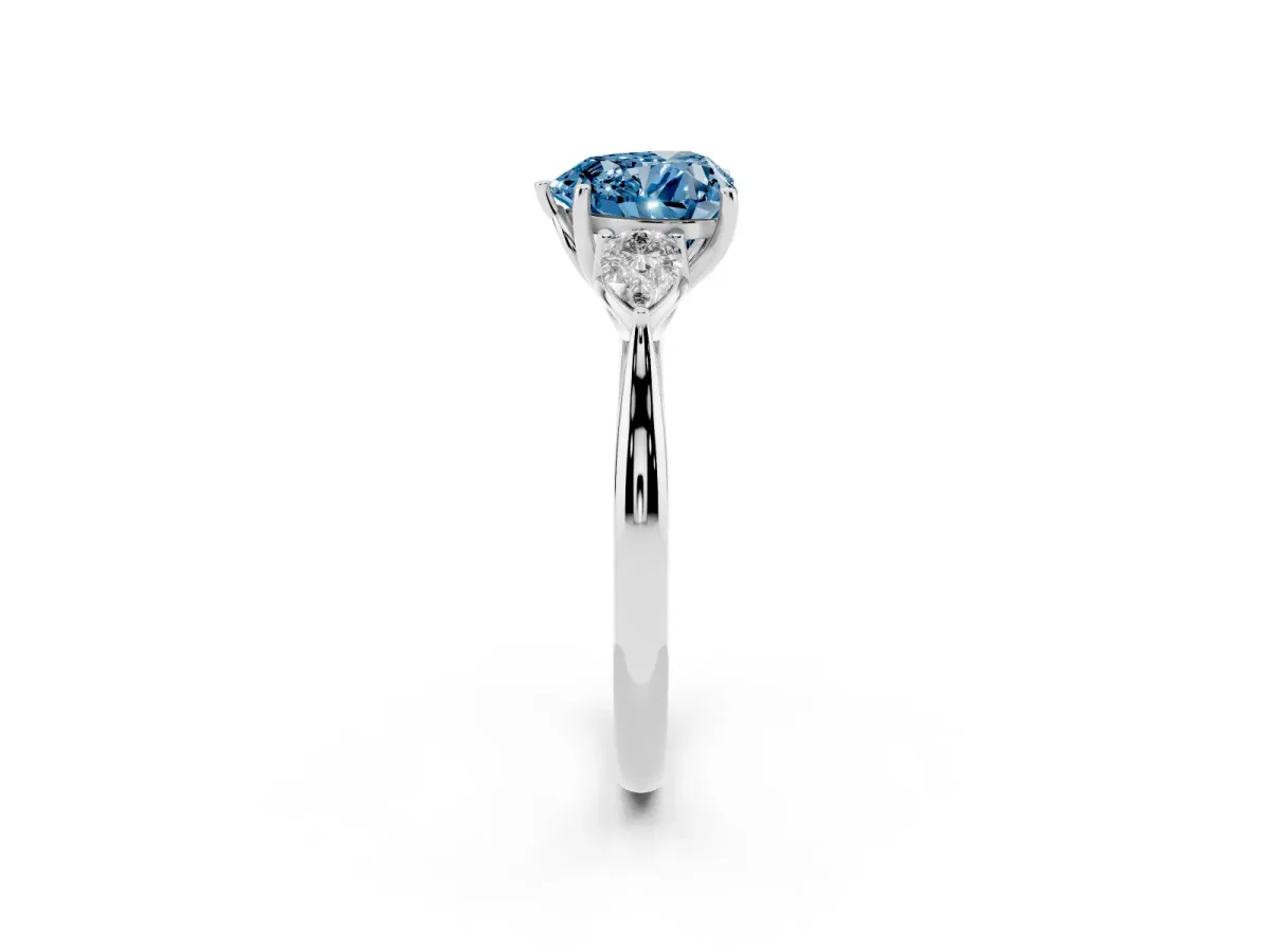 Fancy Blue Three-Stone Heart Cut Brilliant Diamond Solitaire Ring with Tapered Band and Four-Prong Setting White gold