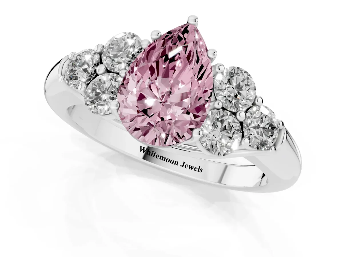 Fancy Pink Pear Cut Cut Diamond Cluster Ring with Round Accent Stones and Prong Setting on a Classic Band White gold