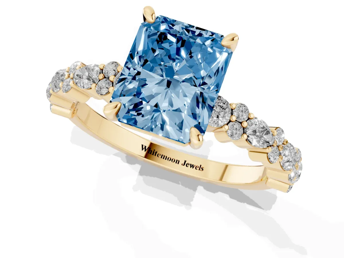 Fancy Blue Radiant Cut Diamond Side Stone Solitaire Ring with Round and Four-Prong Setting Yellow gold