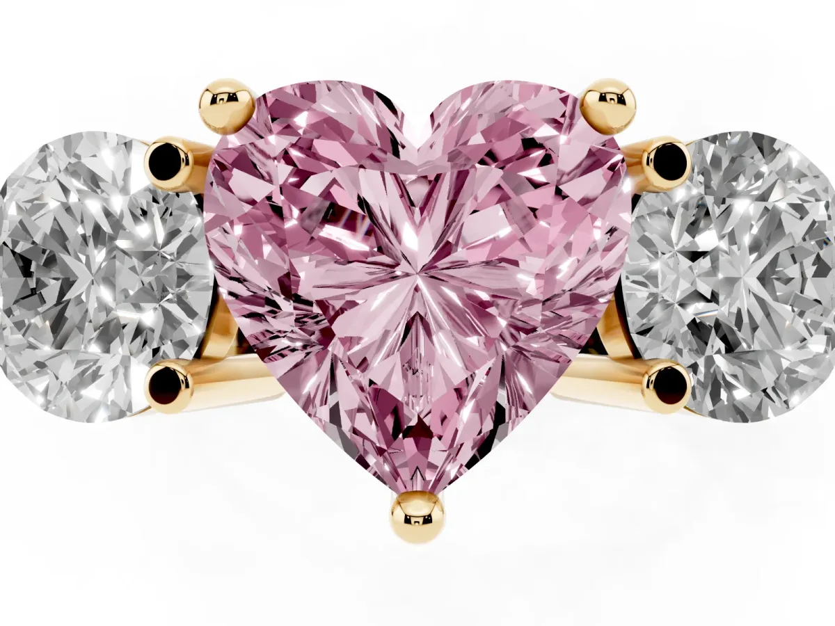 Fancy Pink Three-Stone Heart Cut Brilliant Cut Solitaire Ring with Prong Setting on a Classic Band Yellow gold