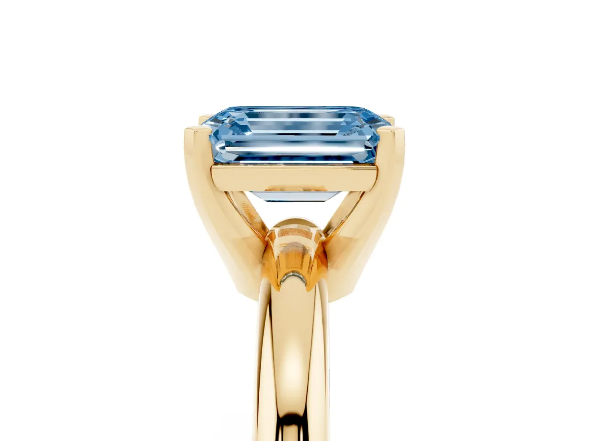 Fancy Blue Emerald Cut Diamond Solitaire Engagement Ring with Round Band and Four-Prong Setting Yellow gold