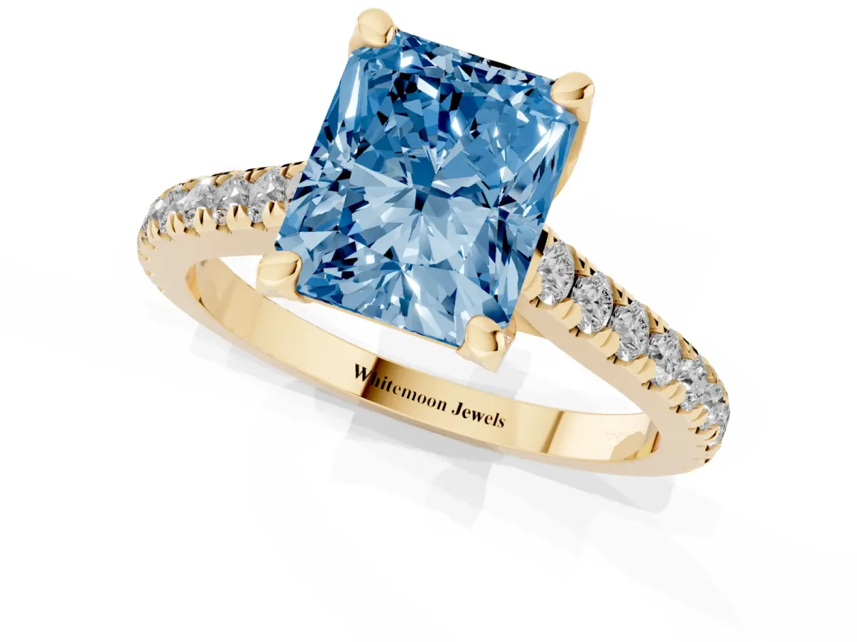 Fancy Blue Radiant Cut Brilliant Diamond Solitaire with Pavé Band and Four-Prong Setting Yellow gold