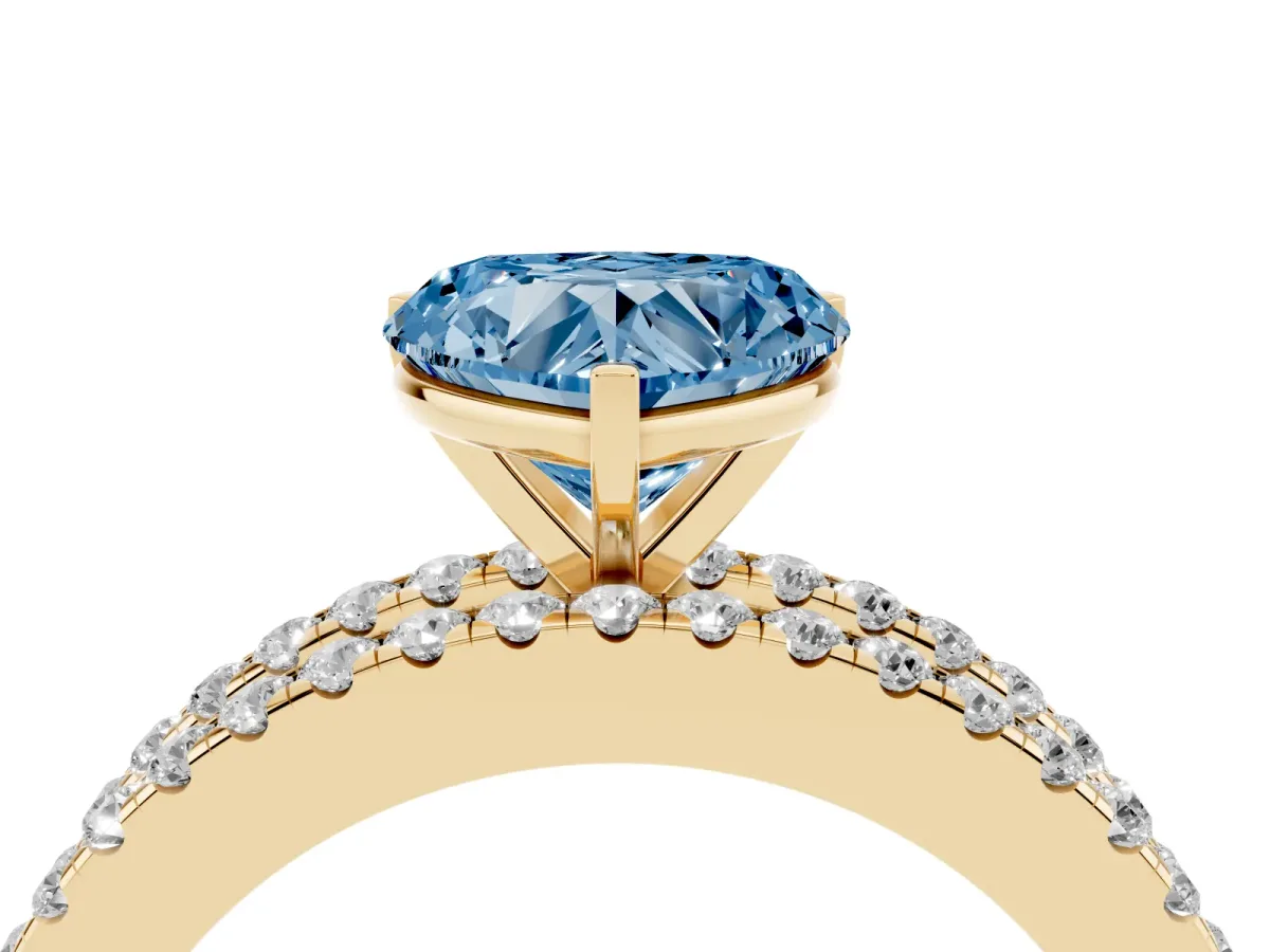 Fancy Blue Heart Cut Diamond Solitaire Ring with Pavé and Channel Set Band Yellow gold