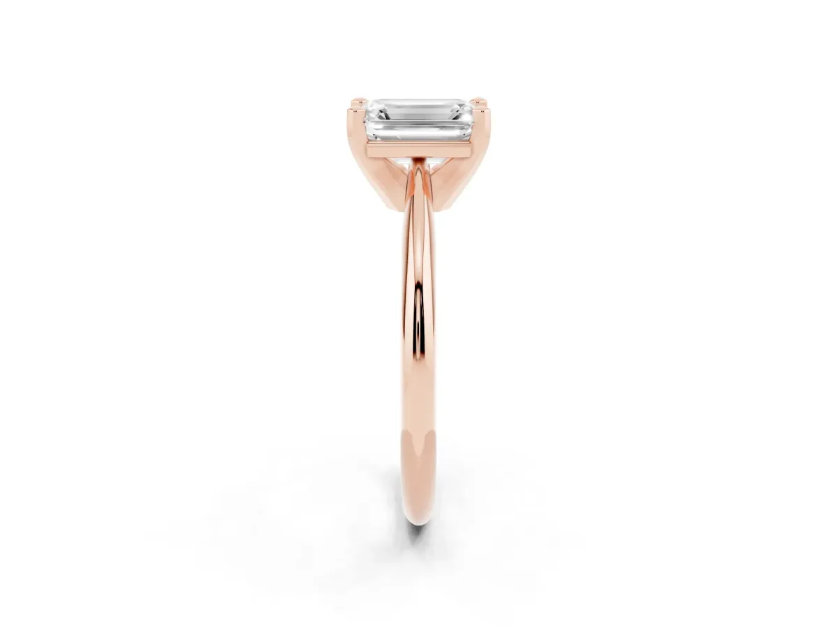 Emerald Cut Cut Solitaire Ring with Four-Prong Setting on a Classic Band Rose gold