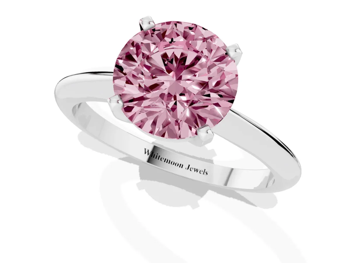 Fancy Pink Round Cut Cut Solitaire Ring with Four-Prong Setting on a Classic Band Silver
