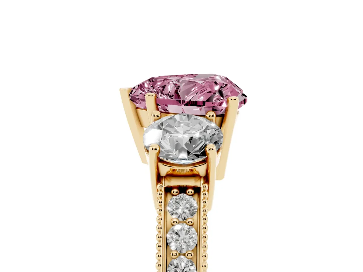 Fancy Pink Heart Cut Three-Stone Diamond Ring with Pavé Band and Four-Prong Setting Yellow gold