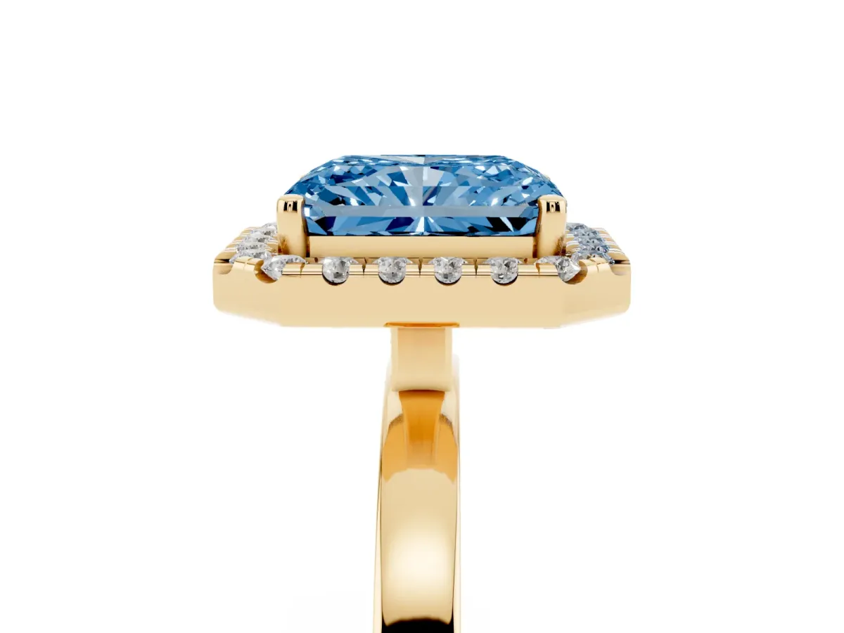 Fancy Blue Radiant Cut Halo Diamond Solitaire with Pavé Band and Four-Prong Setting Yellow gold