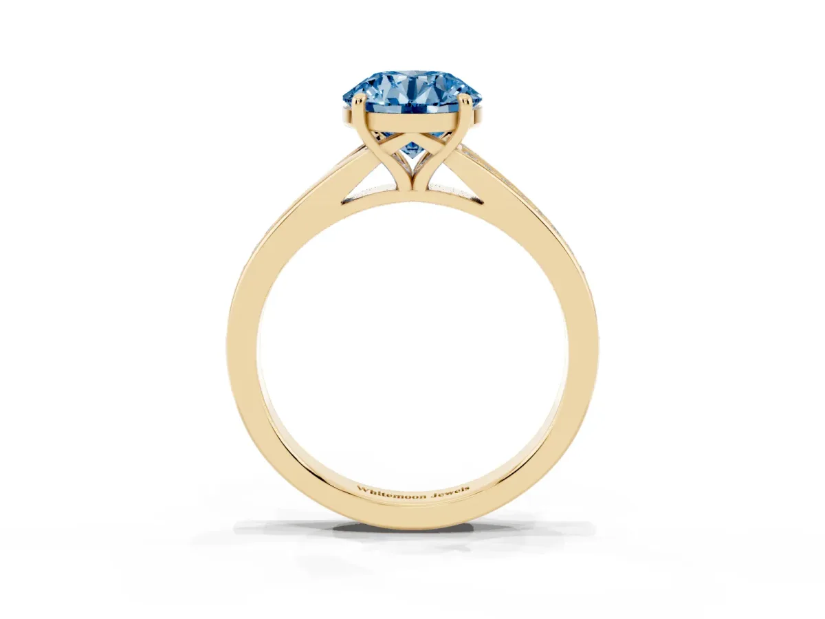 Fancy Blue Round Cut Diamond Solitaire Ring with Pavé Band and Prong Setting Yellow gold