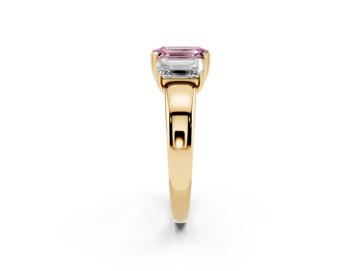 Fancy Pink Three-Stone Emerald Cut Cut Diamond Ring with Channel Set Band and Four-Prong Setting Yellow gold
