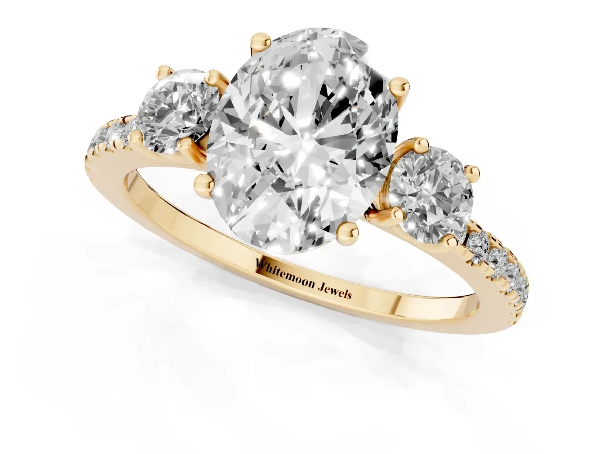 Three-Stone Oval Cut Cut Diamond Pavé Band with Prong Setting Yellow gold