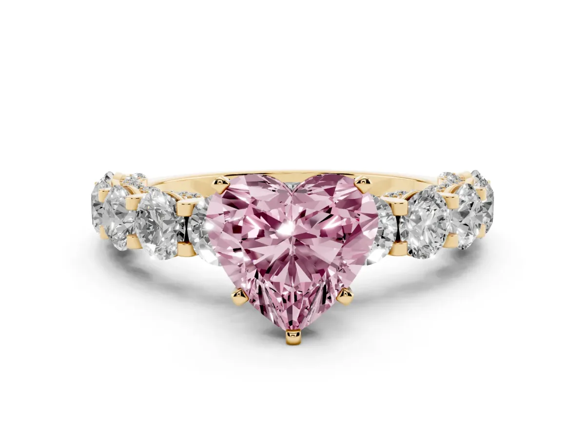 Fancy Pink Heart Cut Diamond Side Stone Engagement Ring with Four-Prong Setting Yellow gold