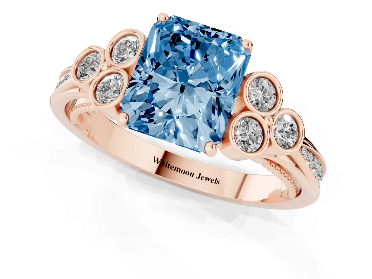 Fancy Blue Radiant Cut Cut Diamond Engagement Ring with Bezel Set Round Side Stones and Prong Setting Rose gold