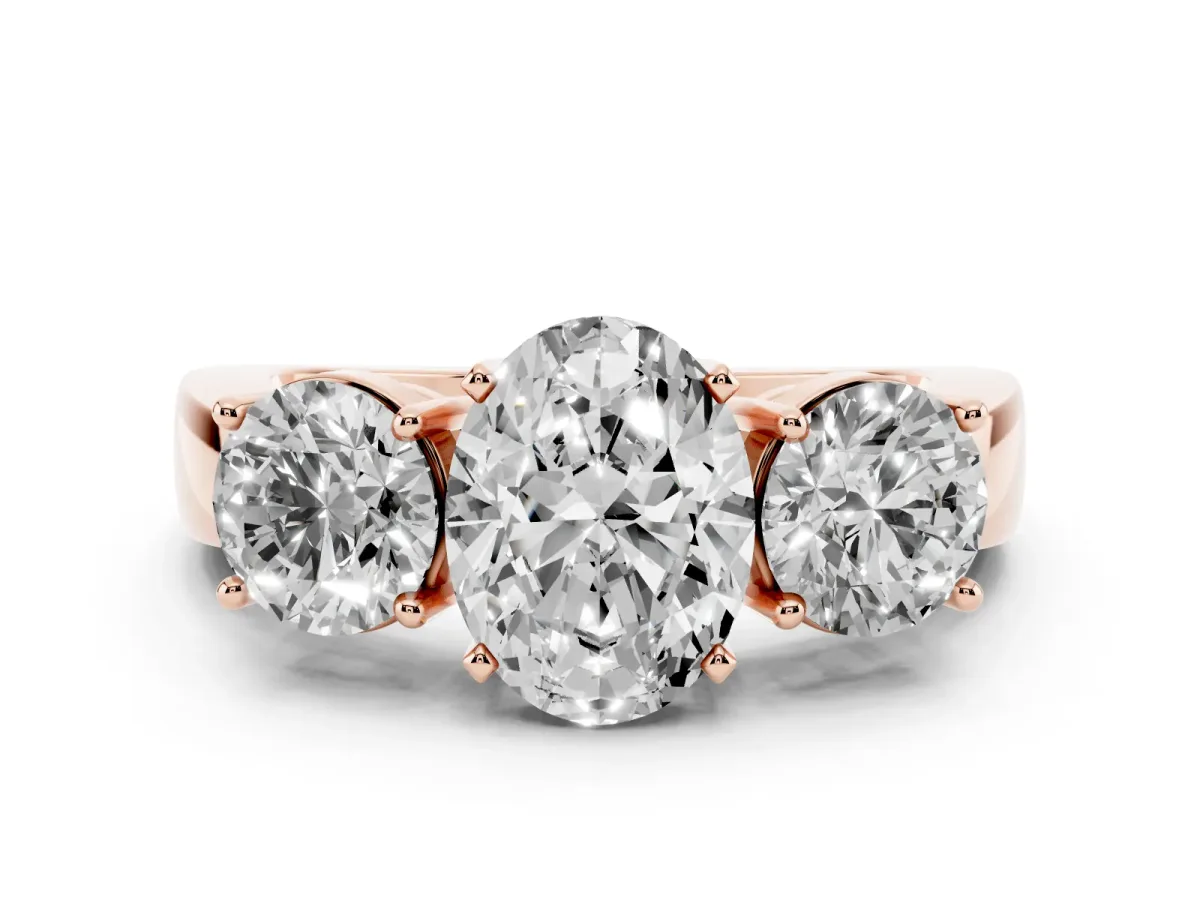 Three-Stone Oval Cut Diamond Ring with Round Side Stones, Classic Band, and Four-Prong Setting Rose gold