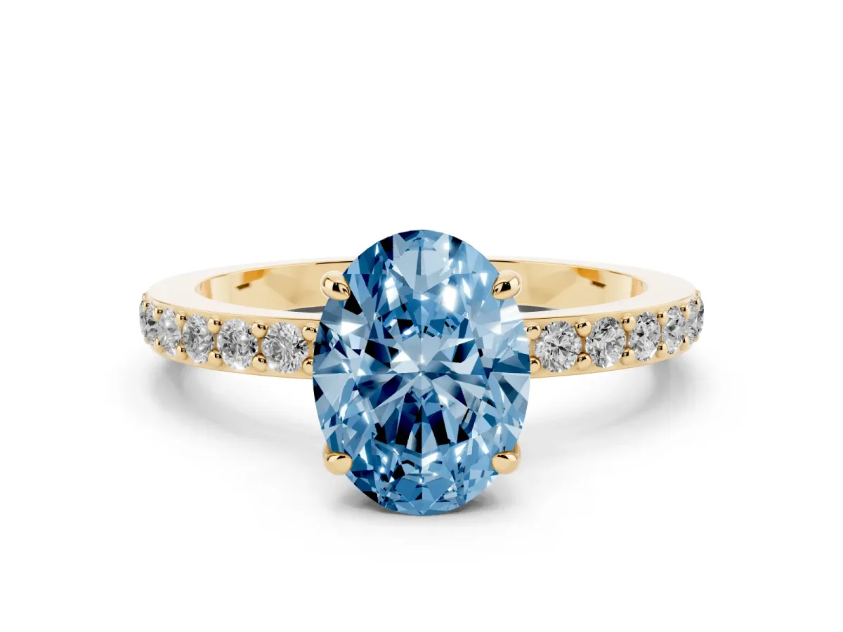 Fancy Blue Oval Cut Diamond Pavé Engagement Ring with Round Accents and Prong Setting Yellow gold