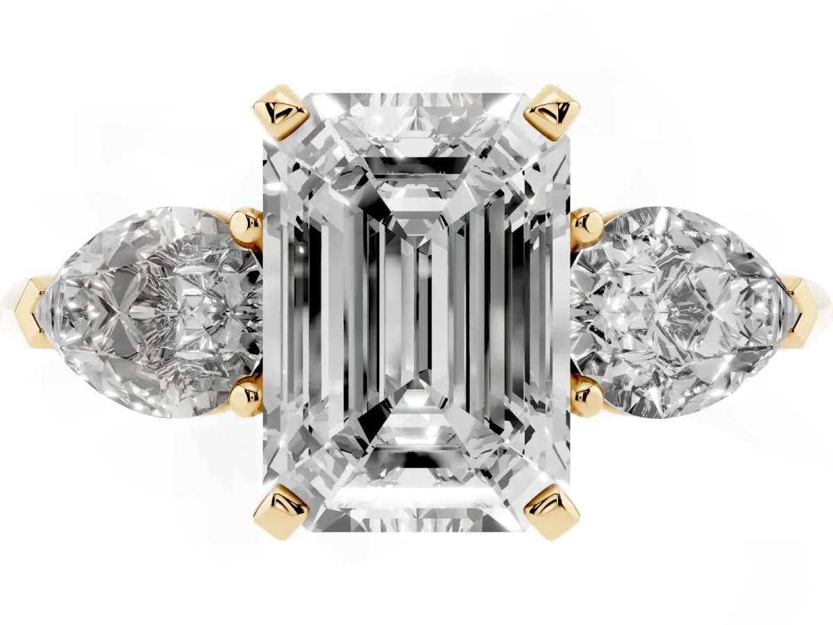 Three-Stone Emerald Cut Diamond Ring with Pear Side Stones and Four-Prong Setting Yellow gold