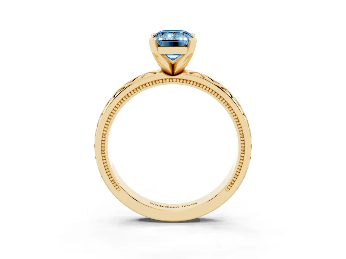 Fancy Blue Emerald Cut Solitaire Diamond Ring with Milgrain and Black Enamel X Pattern Band Yellow gold
