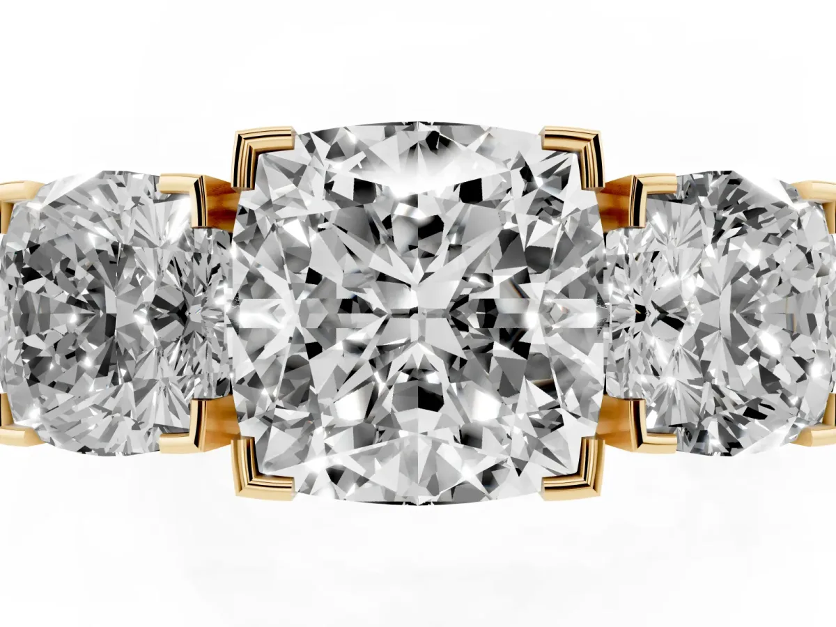Three-Stone Cushion Cut Cut Diamond Ring with Channel Set Band and Four-Prong Setting Yellow gold