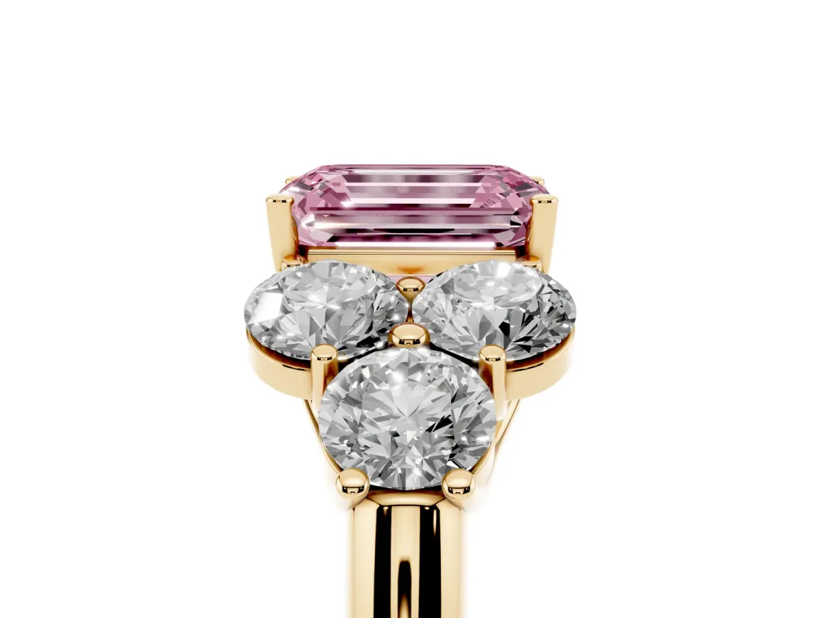 Fancy Pink Emerald Cut Cut Diamond Cluster Ring with Round Accent Stones and Prong Setting on a Classic Band Yellow gold