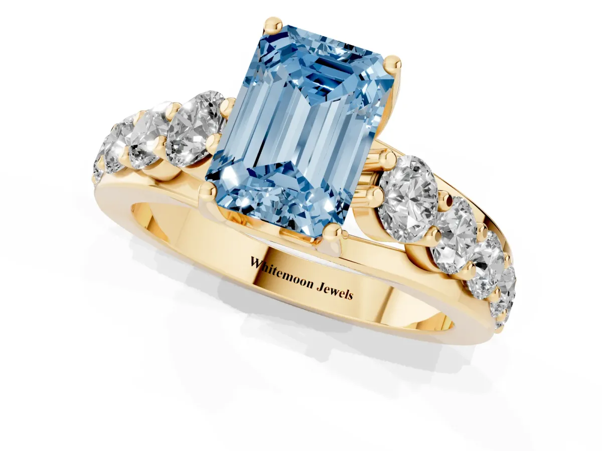 Fancy Blue Emerald Cut Diamond Engagement Ring with Pavé Band and Four-Prong Setting Yellow gold