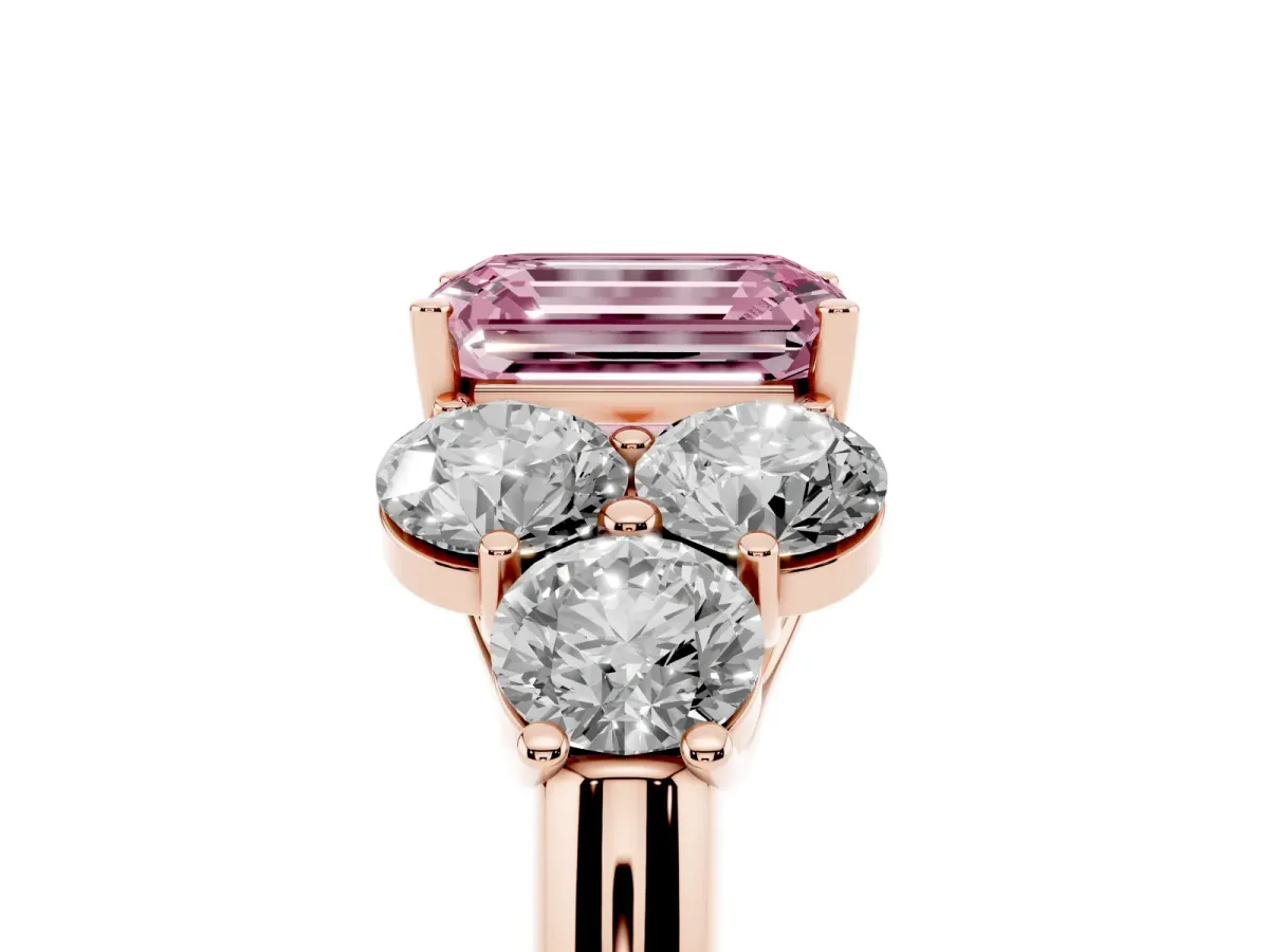 Fancy Pink Emerald Cut Cut Diamond Cluster Ring with Round Accent Stones and Prong Setting on a Classic Band Rose gold