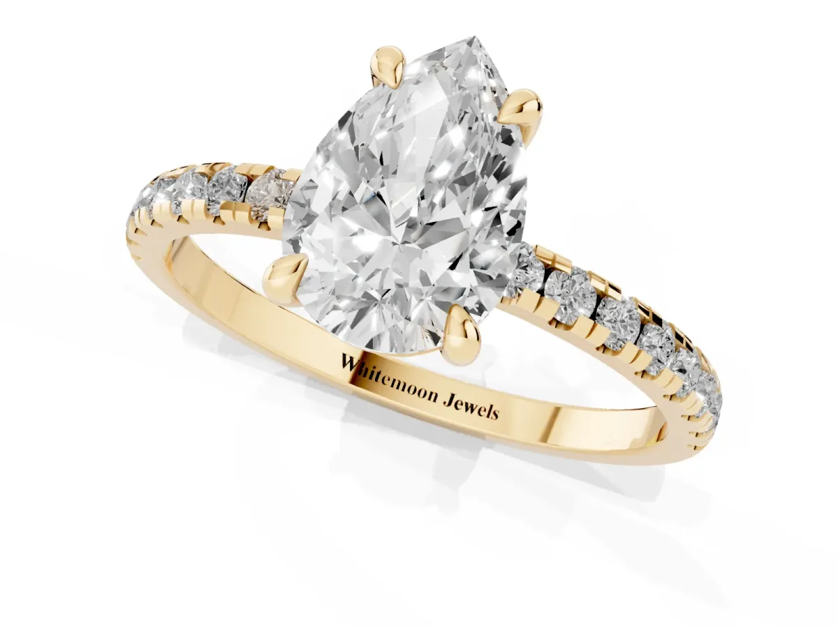 Pear Cut Diamond Brilliant Solitaire Ring with Pavé Band and Four-Prong Setting Yellow gold